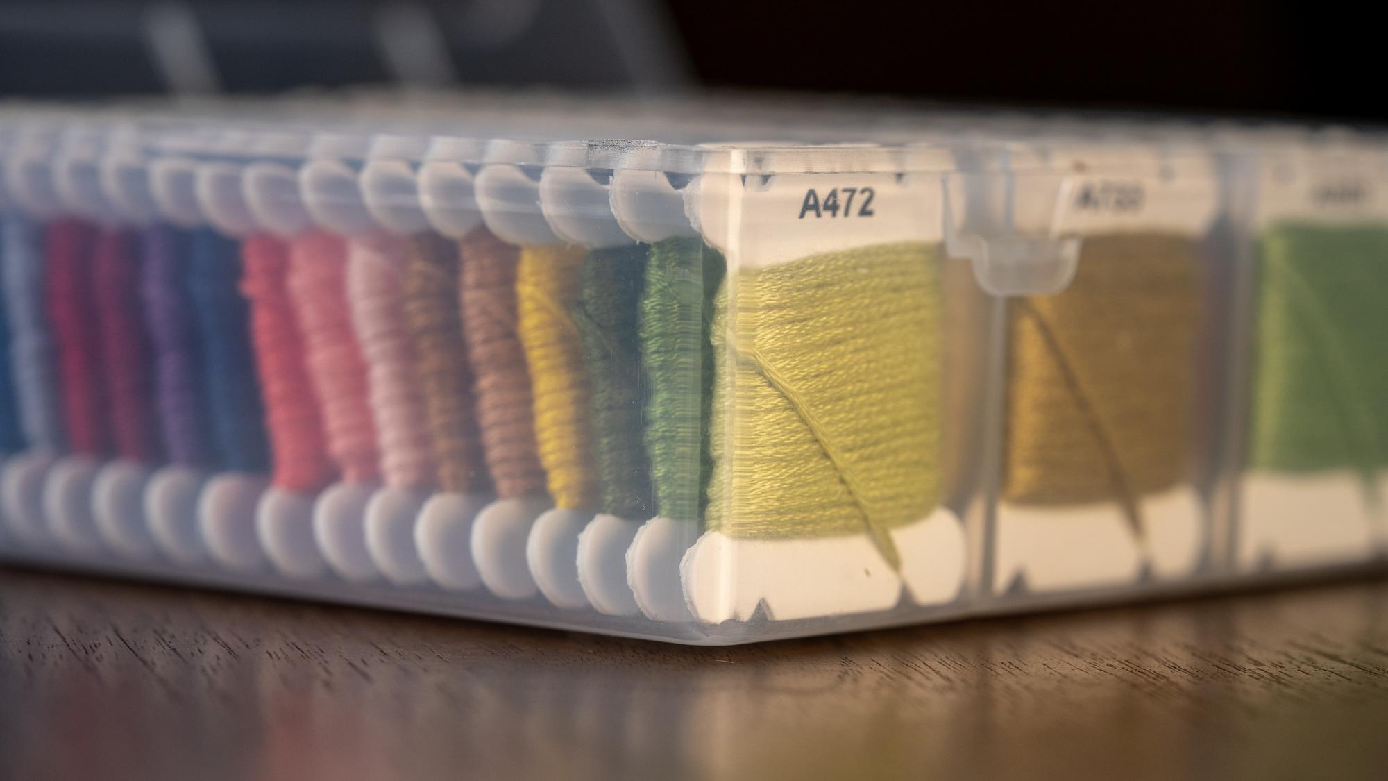 Stack of embroidered samples on grey background